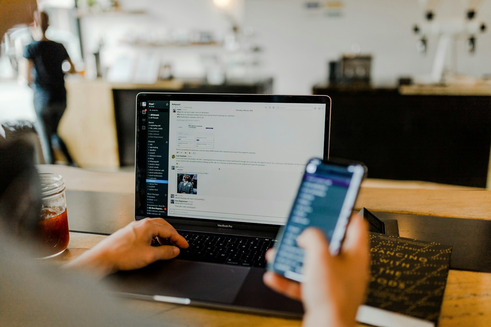 A small business owner reviewing their website on a laptop and phone, checking how it performs for customers