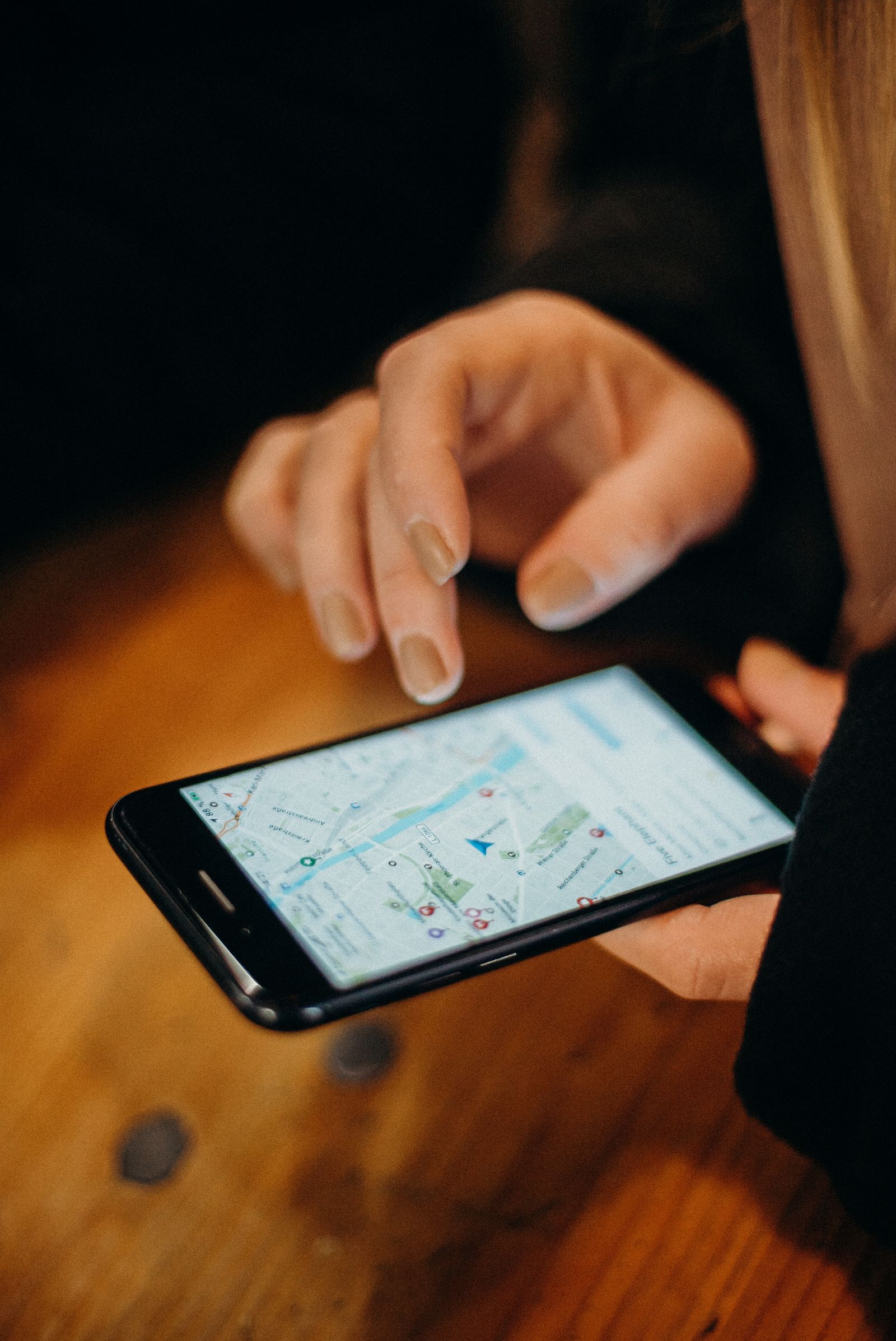 Person using a smartphone map to search for nearby local businesses