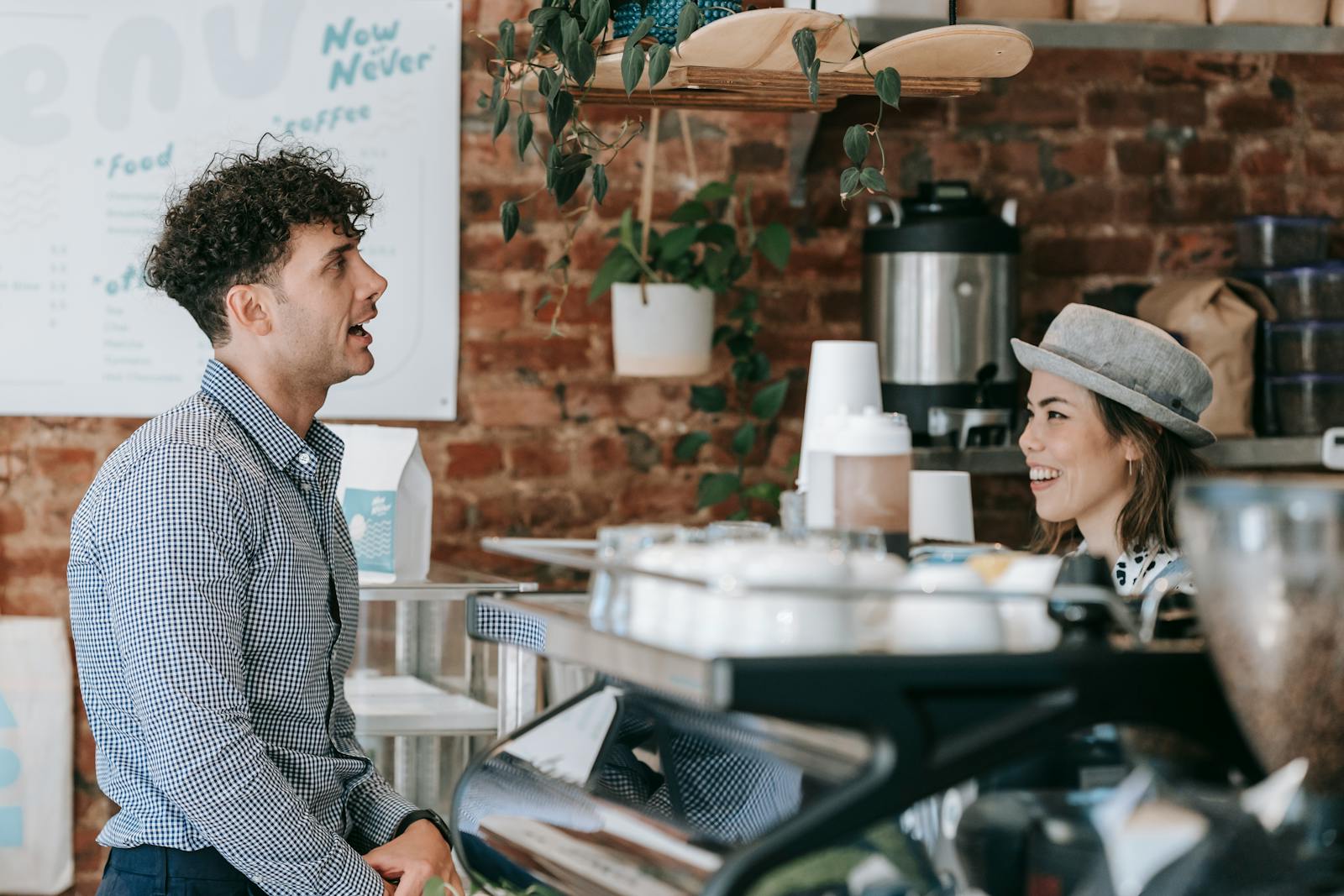 New Zealand small business owner serving a customer at their counter