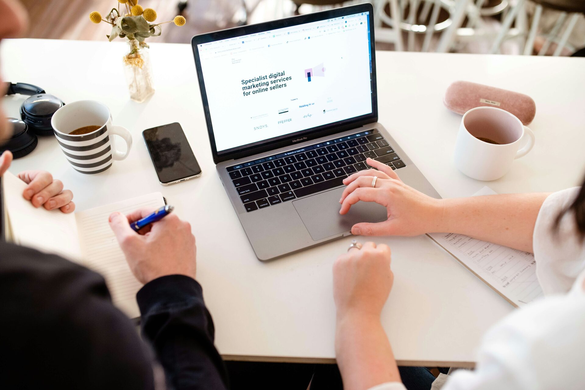 A small business owner reviewing website recommendations at their desk